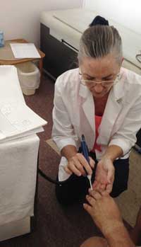 Dr. Wesley performing accupressure on a patient's foot